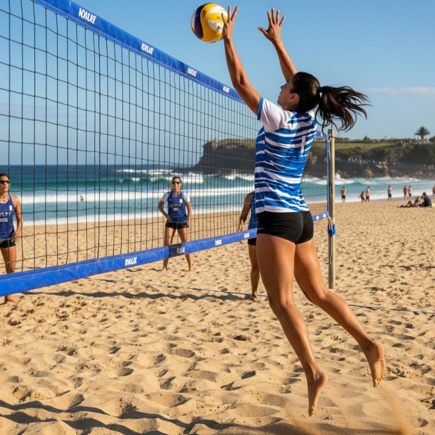 Woman playing beach volleyball on a sandy court with ocean view in jersey shirt 145 - kca sports custom teamwear
